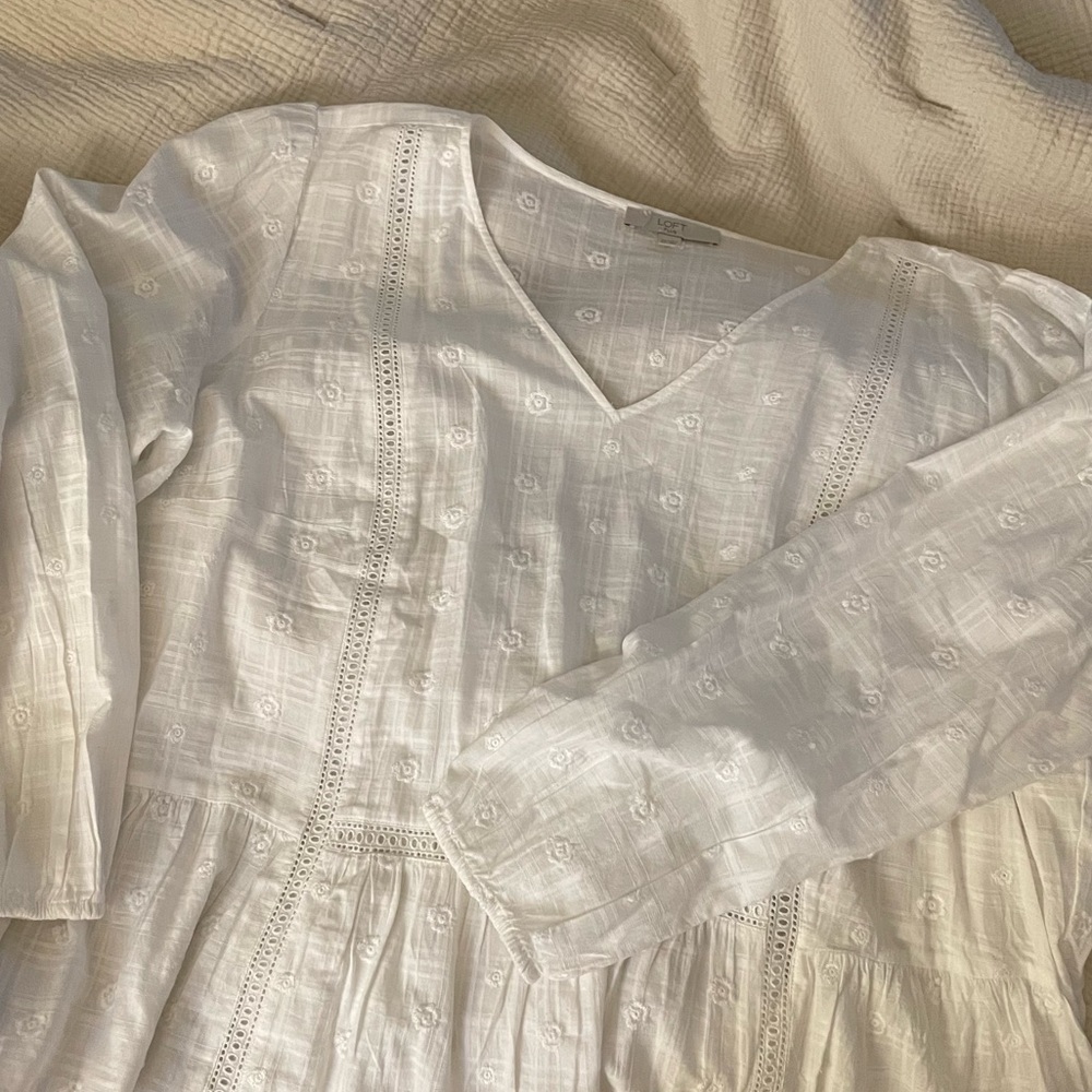 Crisp white flowy top with floral embroidered details
